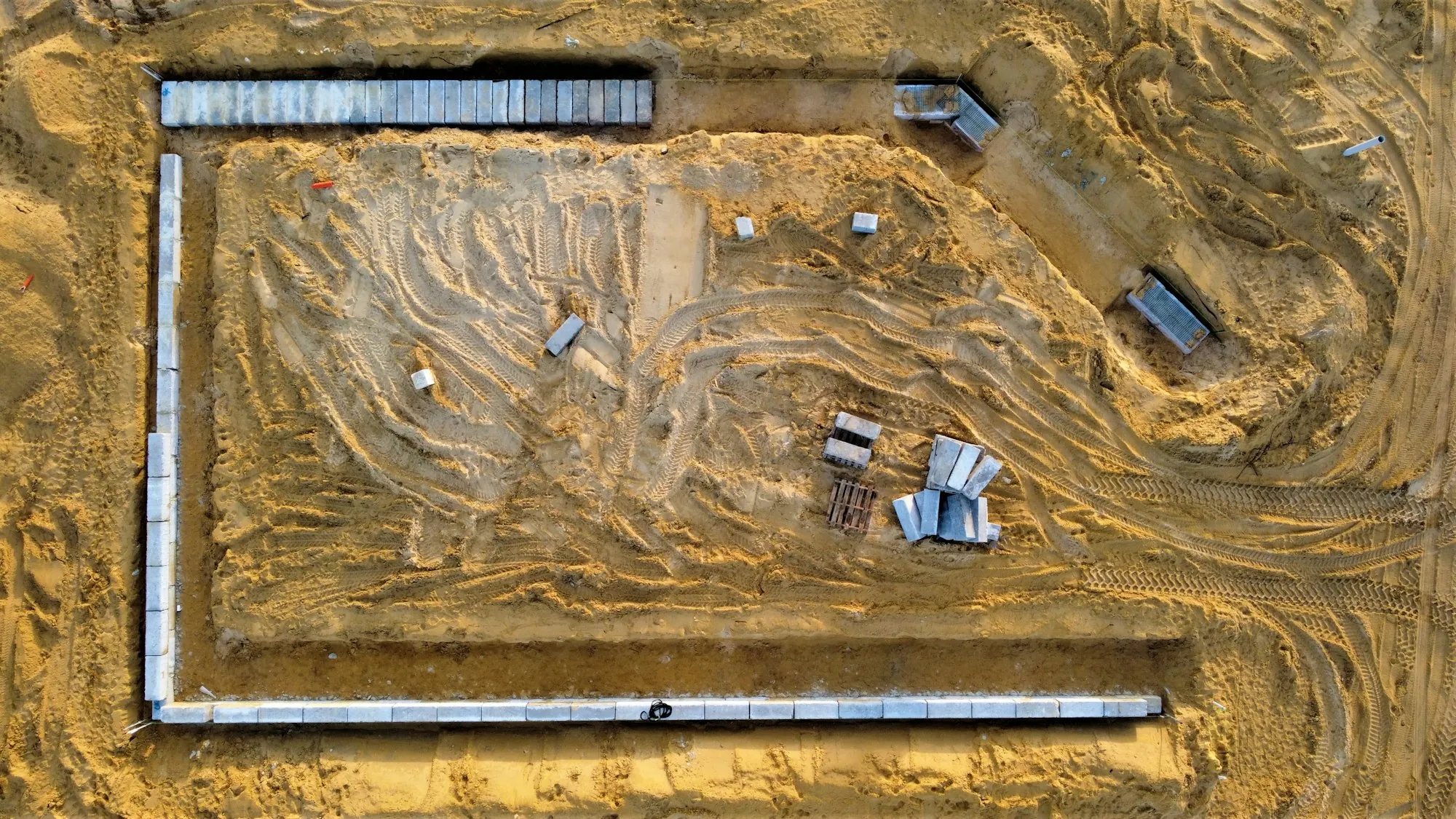 Aerial view of foundation forms on a sandy lot